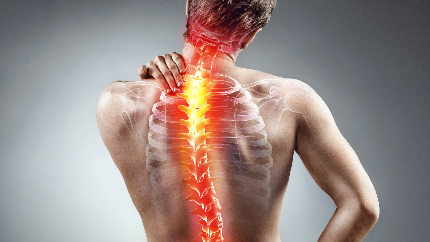 Young man holding his neck in pain. Medical concept.